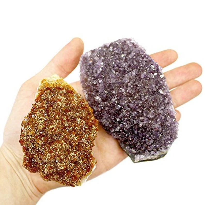 amethyst crystal and Citrine crystal in a hand for size reference