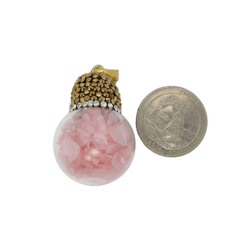 One rose quartz pendant next to a quarter on a white background showing it is larger than the quarter.