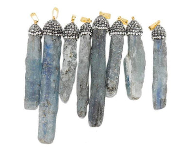 multiple kyanite pendants displayed to show the differences in the color shades and sizes. available in gold