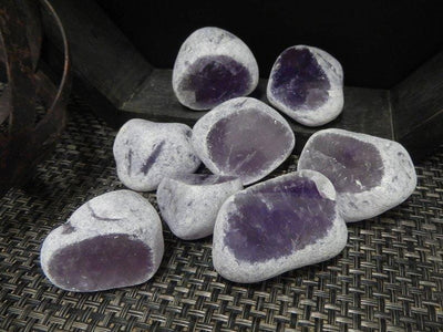 tumbled amethyst seer stones on display for possible variations