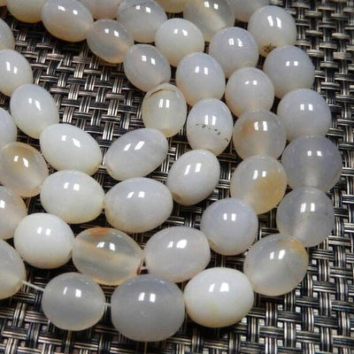 White Agate Egg Shaped Beads on strands showing color variations.