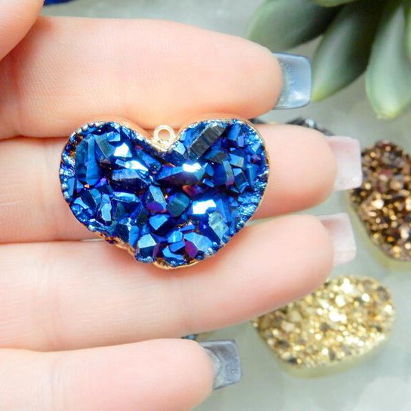 blue pendant in a hand