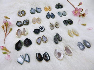 Geode Druzy Pairs lined up on a table to show how they vary in color and shape and size