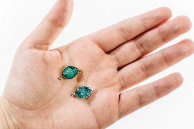 teal druzy marquise sideways double bail displayed in gold and silver in hand for size reference