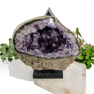 Amethyst Geode on a black stand which is not included.