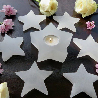 selenite stars on display with selenite star candle holder