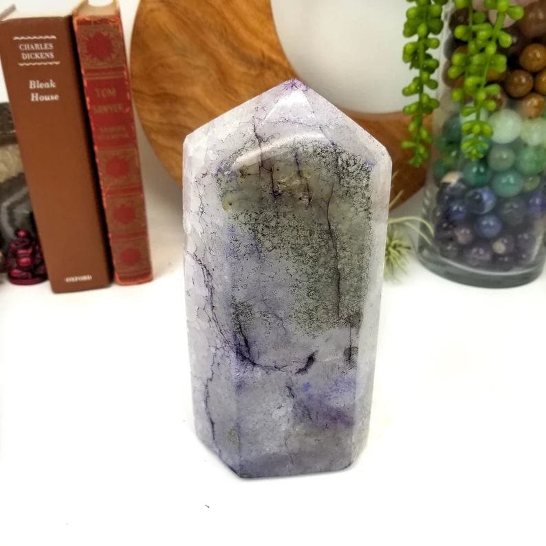 Polished purple dyed agate cut base point on display, showing back side