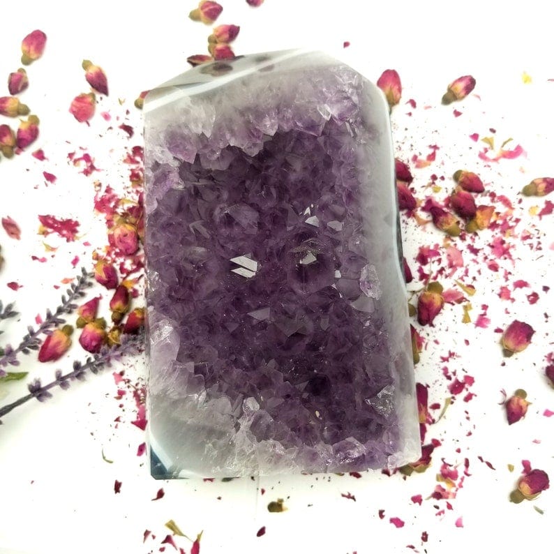 Amethyst Crystal Cut Base with decorations in the background