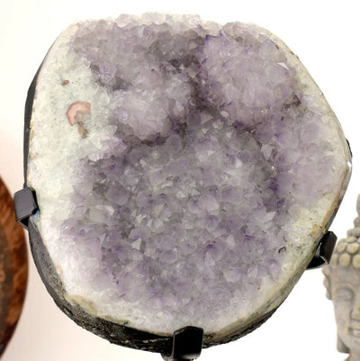 up close Amethyst Crystal Purple Geode on Metal Stand