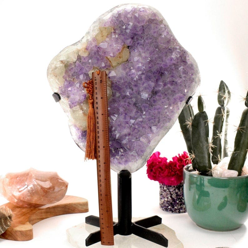 Amethyst Crystal Purple Geode on Metal Stand next to a ruler for size reference with decorations