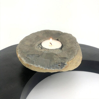 Titanium Geode Candle Holder with Druzy shown with a lit candle