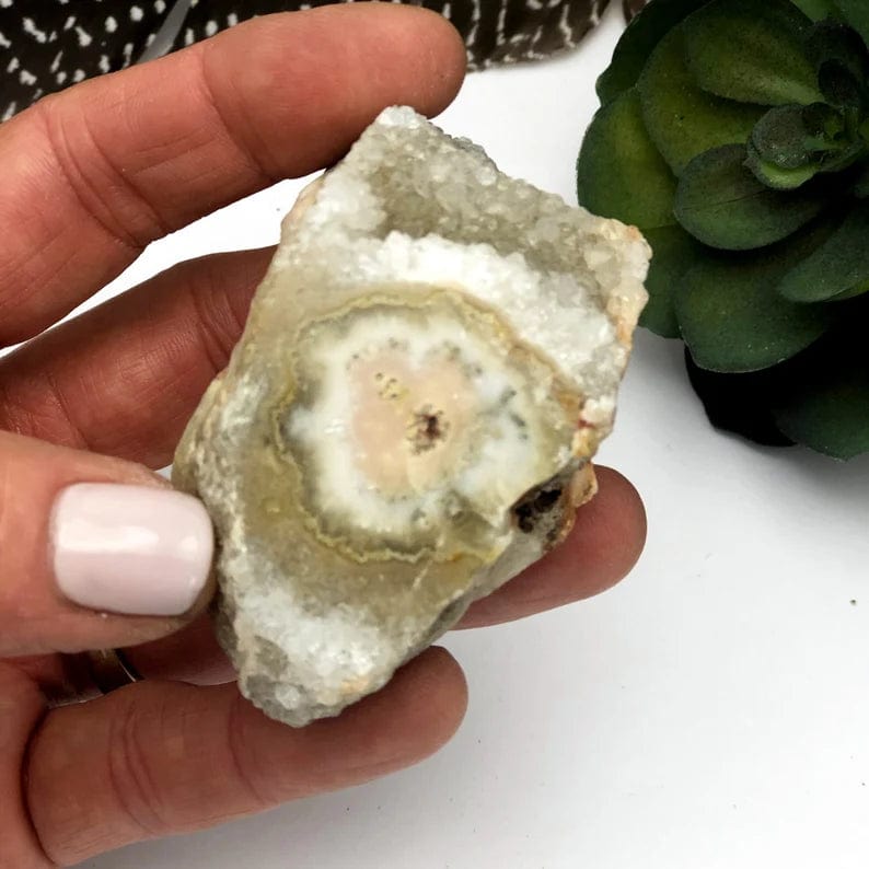 Stalactite Chunk with Druzy in a hand for sizing, shown here close up