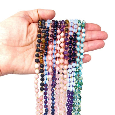 Mala Necklace DIY  assorted stones in a hand for sizing