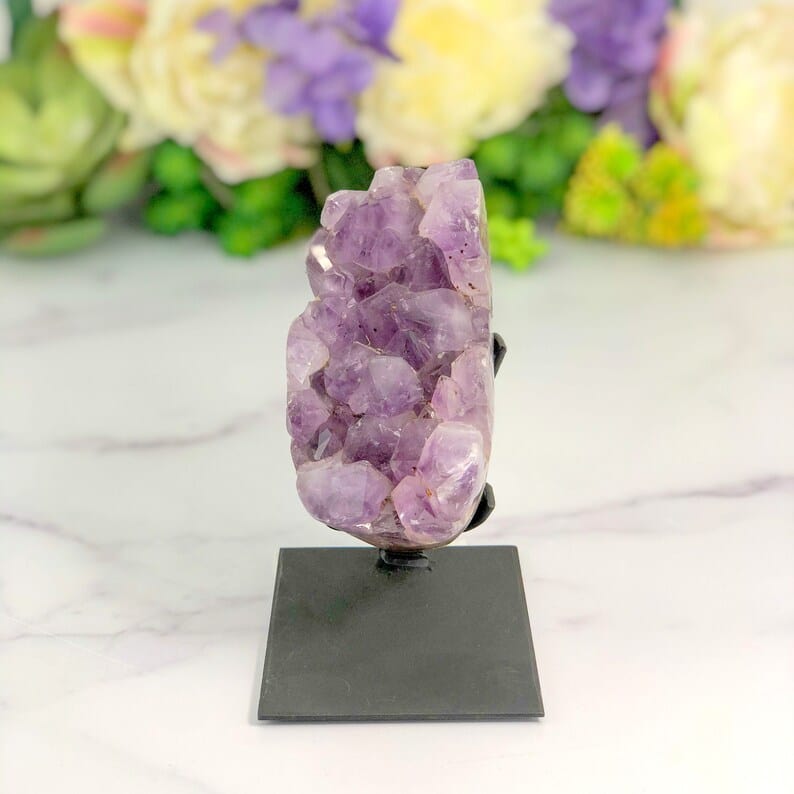 Amethyst Crystal Purple Geode on Metal Stand on display