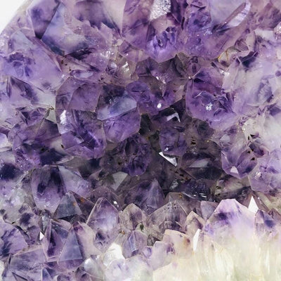 up close shot of Amethyst Purple Geode Crystal on Metal Stand 