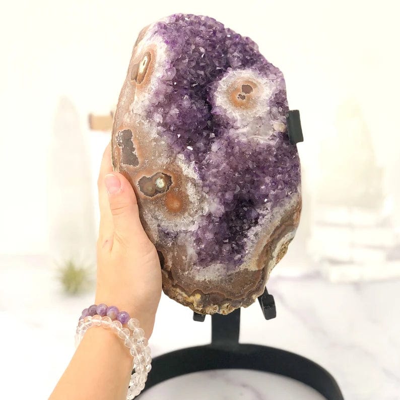 Amethyst Crystal Purple Geode With Stalactite on Metal Stand with hand beside to show size