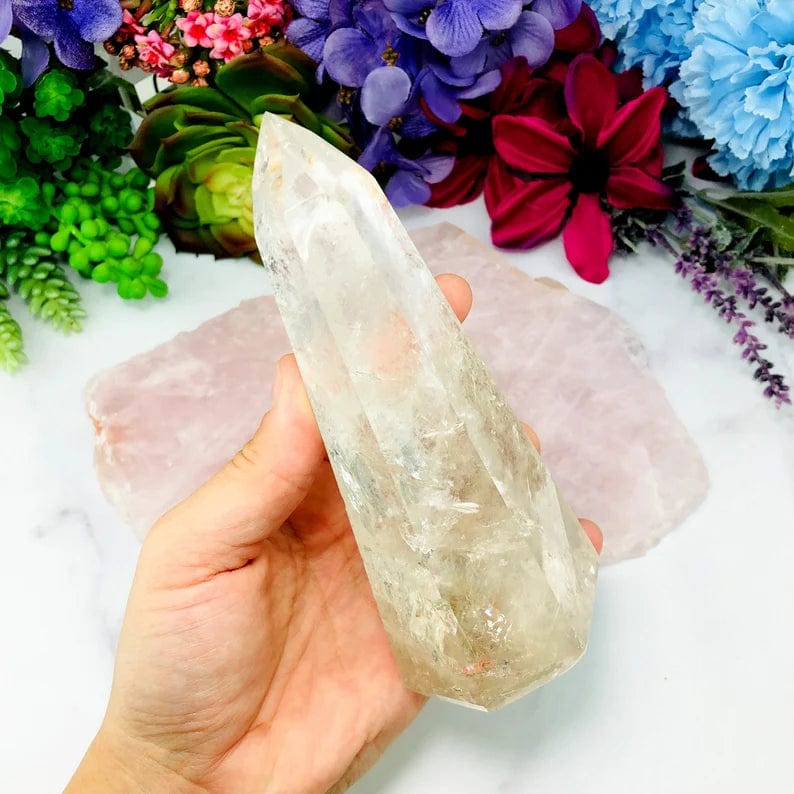Crystal Quartz Polished Tower side view on hand for size comparison