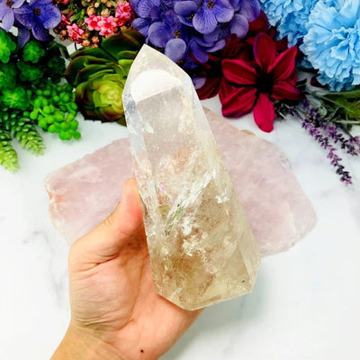 Crystal Quartz Polished Tower on hand for size comparison