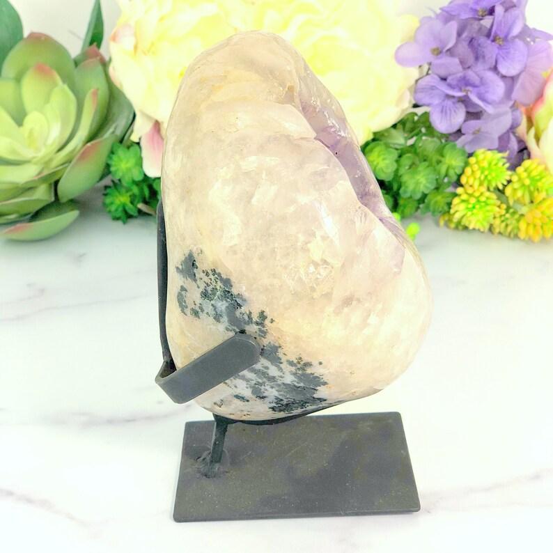 side shot picture of geode on metal stand.
