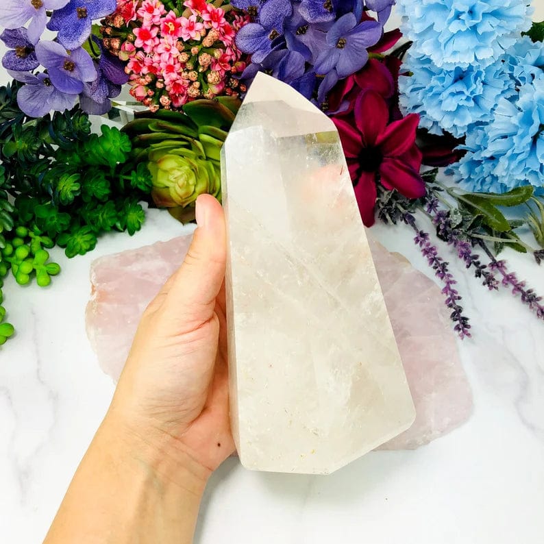 Crystal Quartz Polished Tower in a hand for size reference