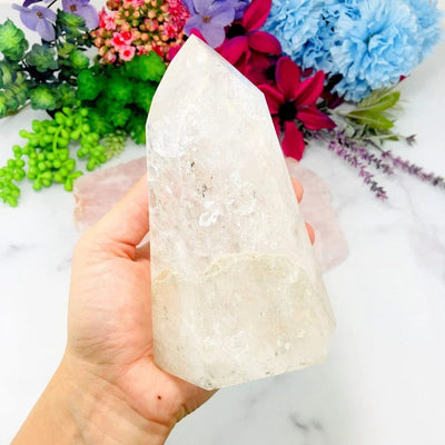 Crystal Quartz Polished Tower on hand for size comparison