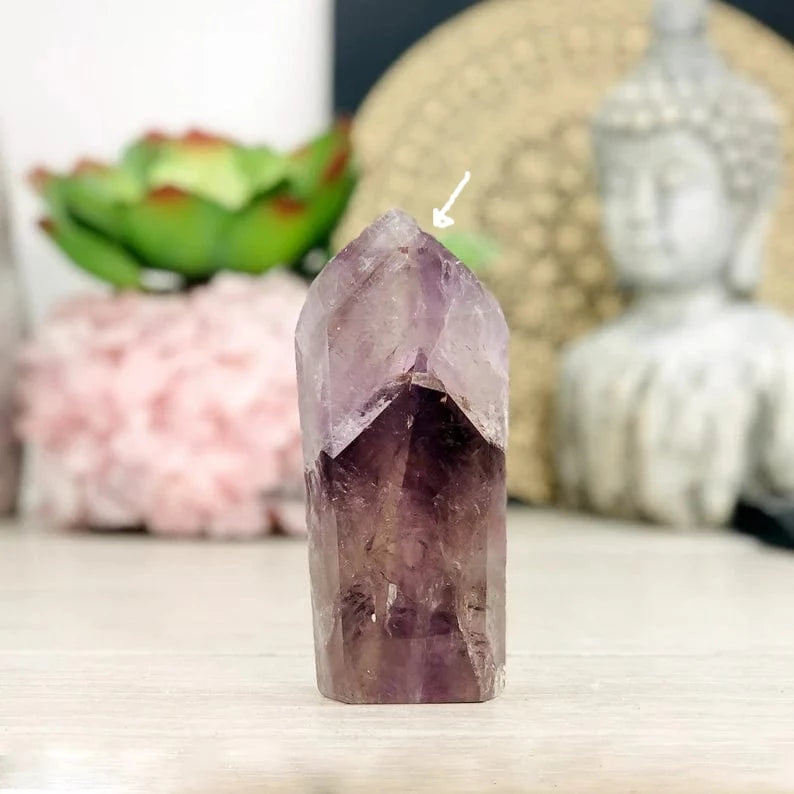 Amethyst Polished Tower Point on display showing the small chip in top edge with an arrow to it