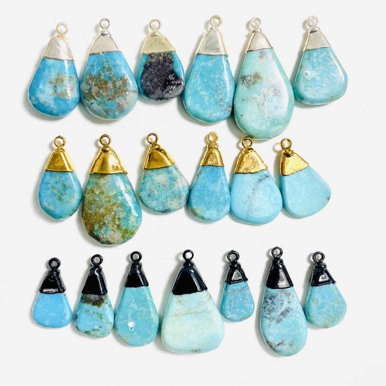 Natural turquoise tear drop pendants.  Pictured in gold plated, silver plated, and black rhodium plated.  They are teardrop shaped and have plating just along the top part.  Small bail, a jumpring would need to be added to make them wearable.