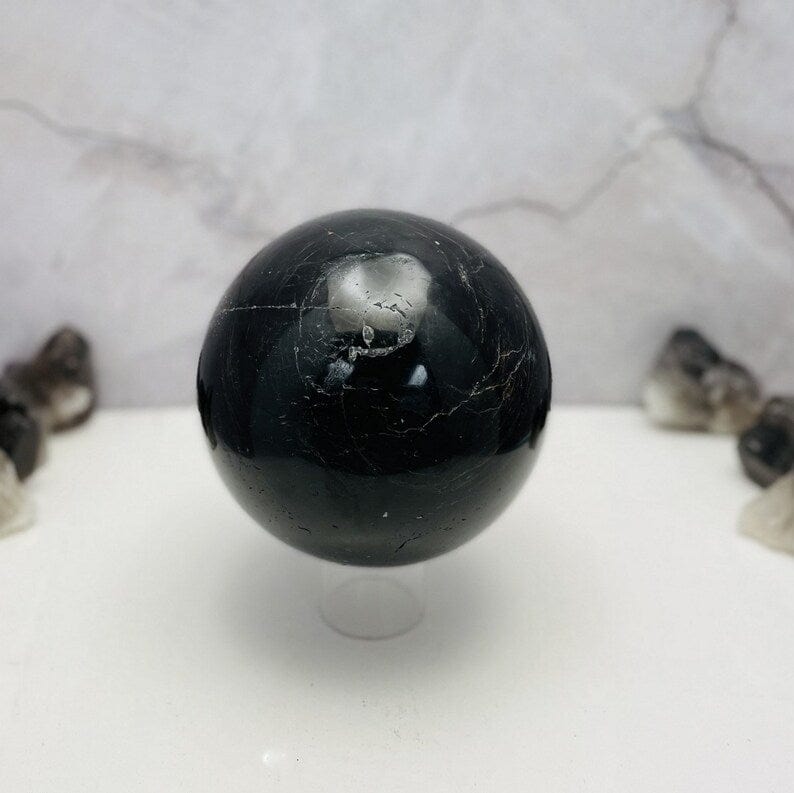 Black Tourmaline with Hematite Polished Sphere on a clear stand (stand not included)