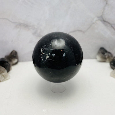 Black Tourmaline with Hematite Polished Sphere showing a few tiny chips in the middle