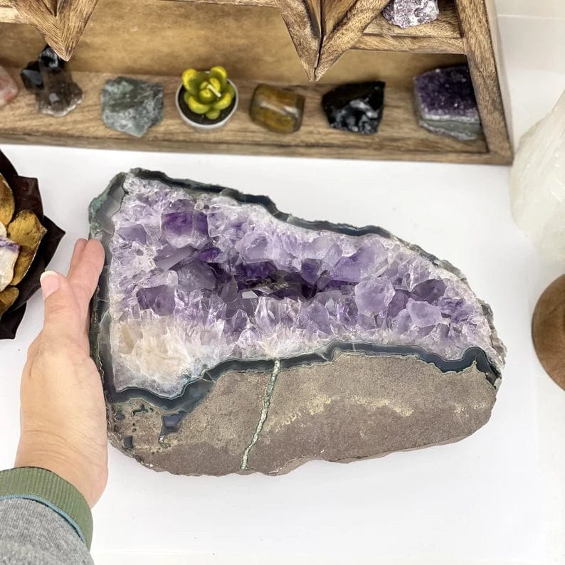 Amethyst platter next to a woman's hand.