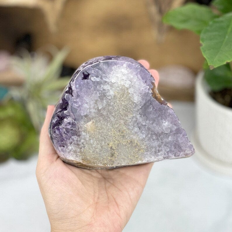 Amethyst Freeform Cut Base in a hand for size reference