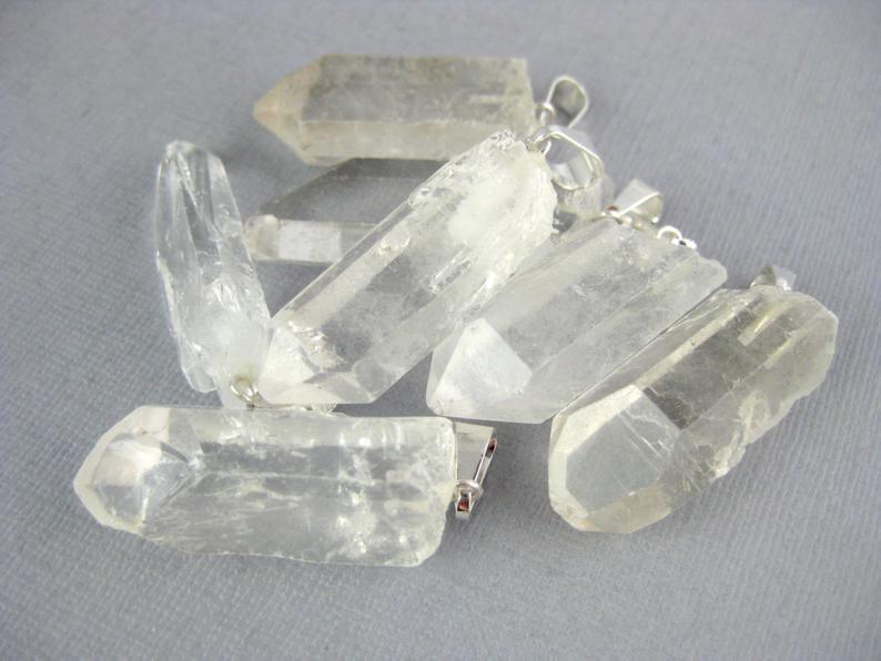 crystal point pendants in a pile