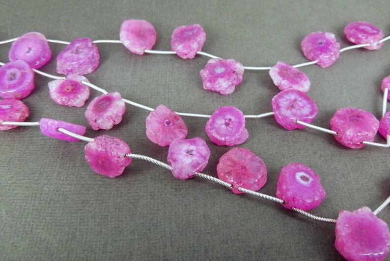 Pink Solar Quartz Beads on strands showing size difference