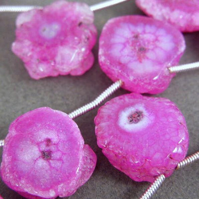Pink Solar Quartz Beads close up of a few on strand to show color/shape variety
