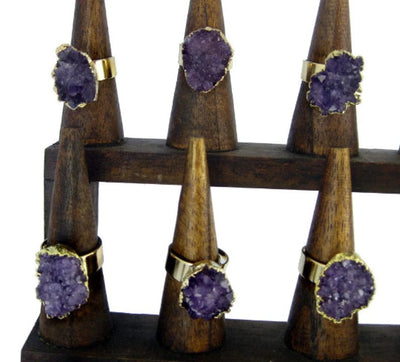 6 different Amethyst Freeform Cluster Druzy Adjustable Ring with Electroplated Gold Edges, showing differnet rings and the stone of different shapes on a display stand