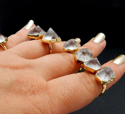 Double Crystal Quartz Point Ring with Electroplated 24k Gold Edges on an adjustable band on fingers from a side angle