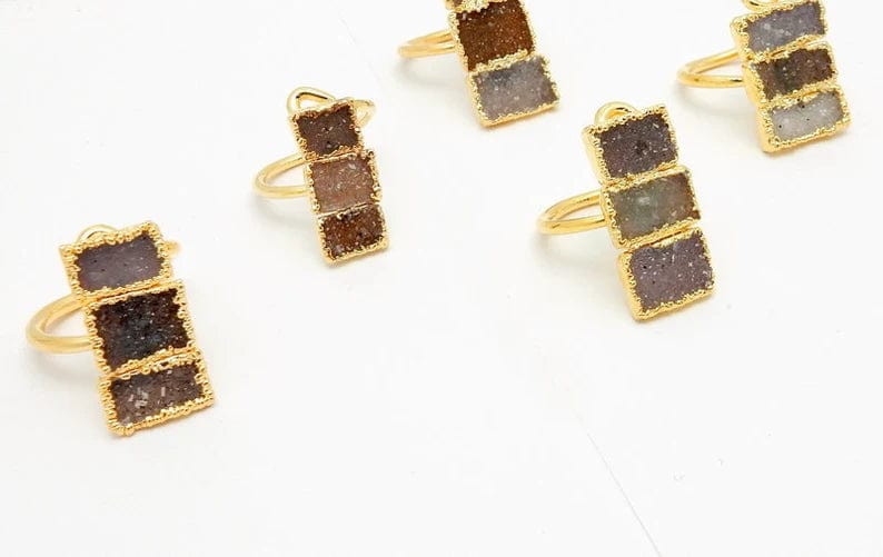 5 Triple Rectangle Druzy with Electroplated 24k Gold Edges on an Adjustable 24k Gold Electroplated Rings showing varying colors of white, tan brown, greys, darks, lavenders