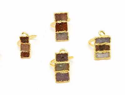 4 Triple Rectangle Druzy with Electroplated 24k Gold Edges on an Adjustable 24k Gold Electroplated Rings showing varying colors of white, tan brown, greys, darks, lavenders