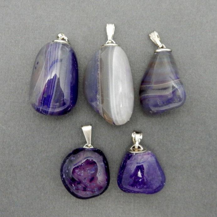 Purple Agate Pendants with silver plated bail displayed to show various colors patterns texture shape and size
