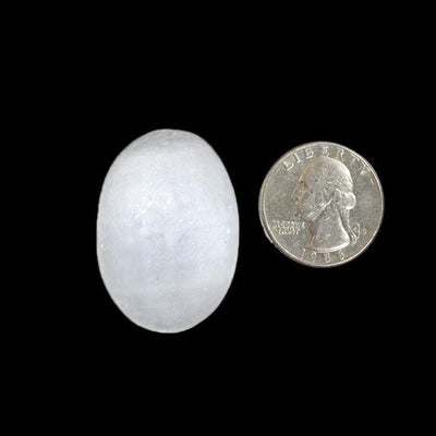 one selenite worry stone slab with quarter for size reference