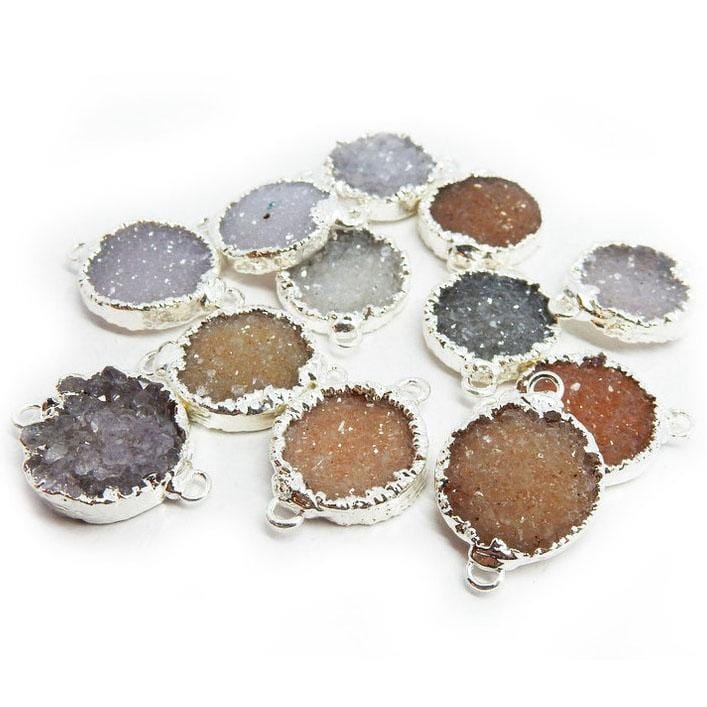 Druzy Double Bail Pendants scattered on white background