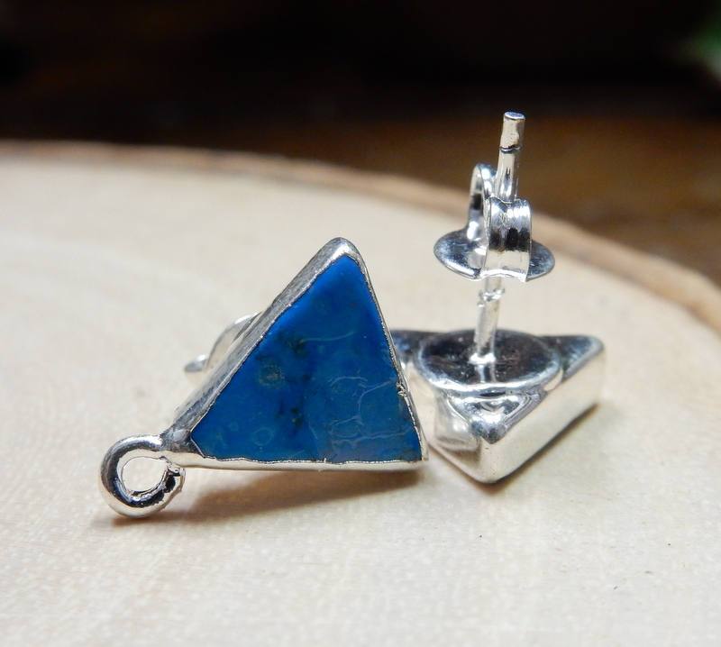 1 pair of Blue/silver Howlite Triangle Stud Earrings with Hoop baill. One flat on table showing back of earring. One laying on it's side