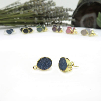 blue oval earrings in gold displayed on white background