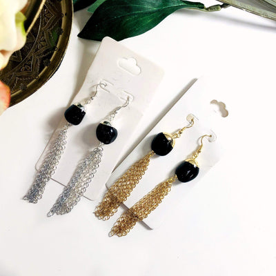 black onyx gold and silver earrings displayed on white background