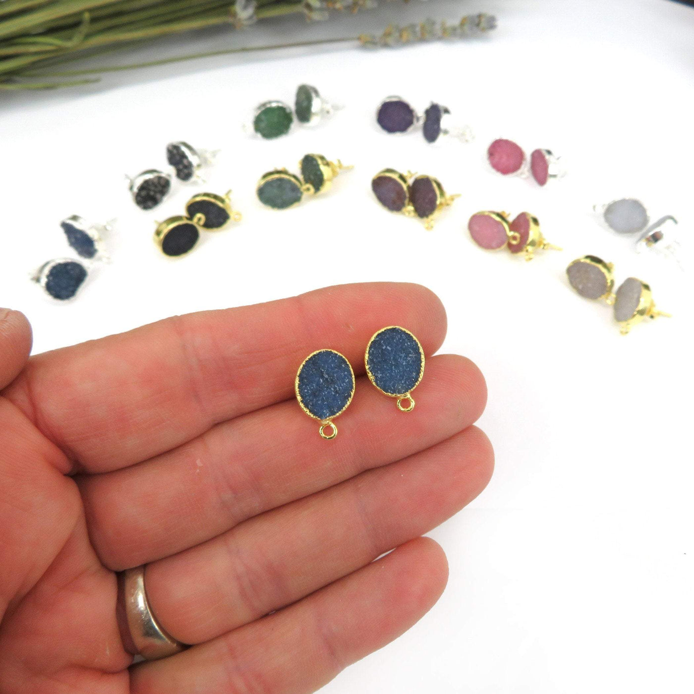 oval earrings displayed in hand for size reference