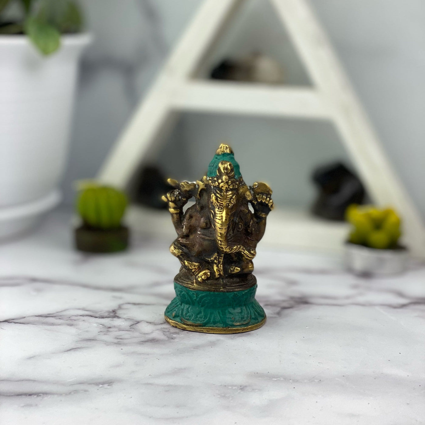 Brass Sitting Posture Elephant Lord Ganesha Mini Statue displayed on white background