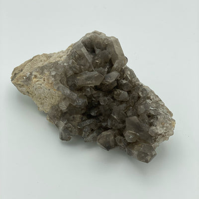 close up of natural smokey quartz cluster on white background for details