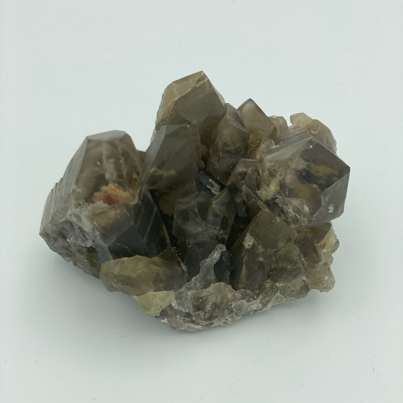 close up of natural smokey quartz cluster on white backdrop for details