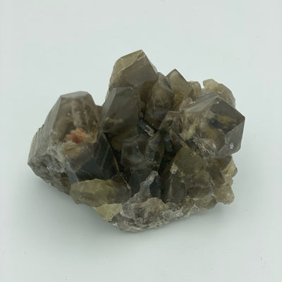 close up of natural smokey quartz cluster on white backdrop for details