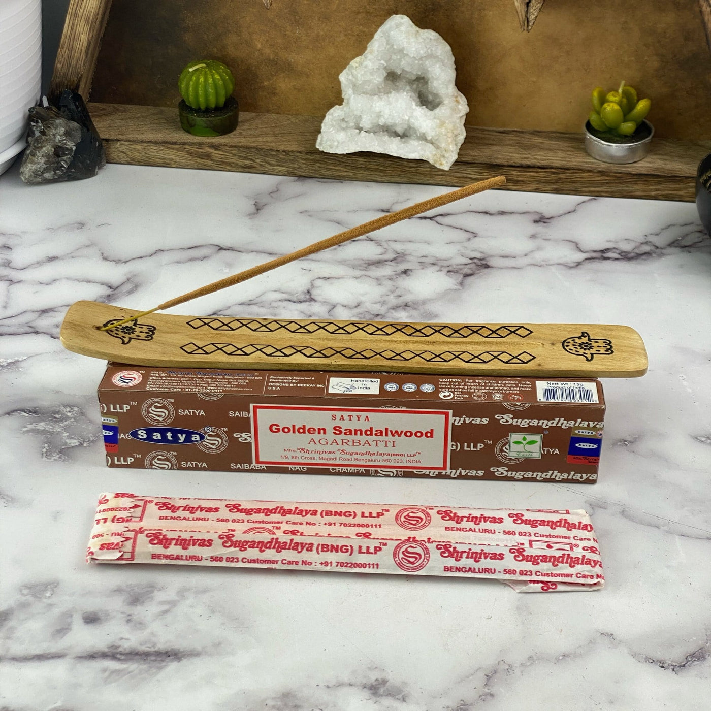 overhead view of satya hand rolled golden sandalwood incense on display